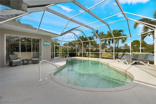 view of swimming pool featuring a patio and glass enclosure