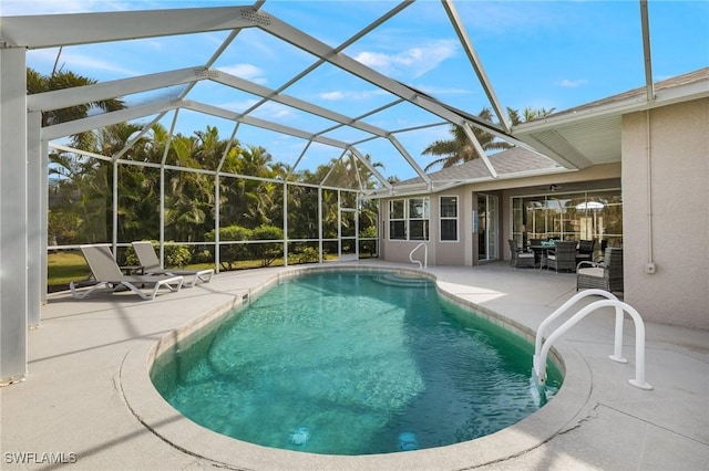 view of pool featuring a patio area and glass enclosure