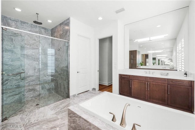 bathroom with vanity and separate shower and tub