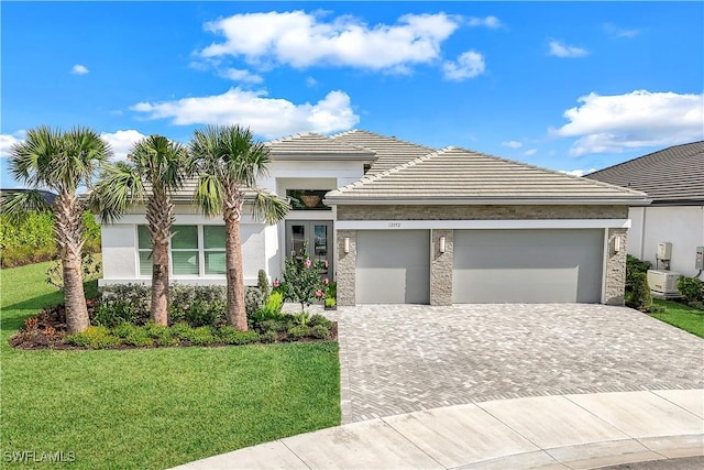 view of front of house with a garage and a front yard