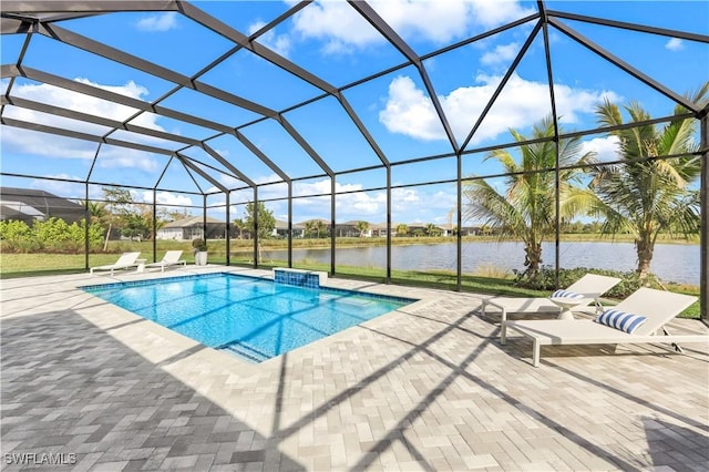 view of pool featuring a patio, a water view, and glass enclosure