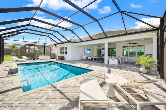 view of pool featuring a lanai, exterior bar, ceiling fan, and a patio area