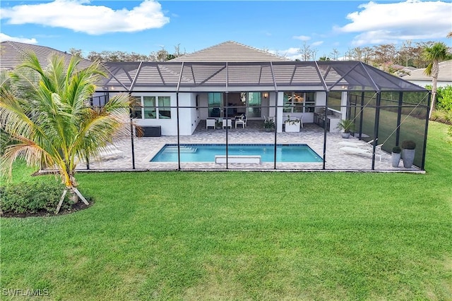 rear view of house with a yard, a lanai, and a patio area