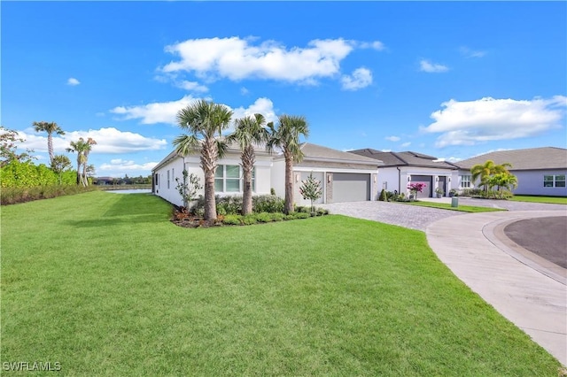 ranch-style house featuring a garage and a front lawn