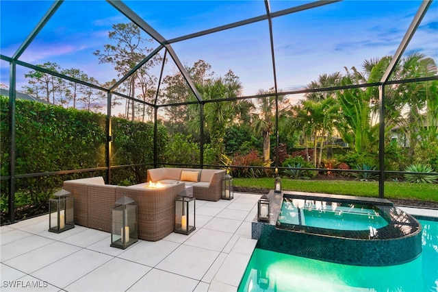 patio terrace at dusk with an outdoor living space and glass enclosure