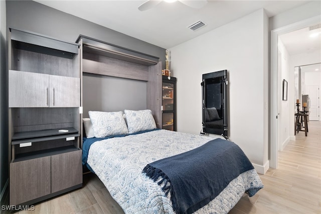 bedroom with ceiling fan and light hardwood / wood-style floors