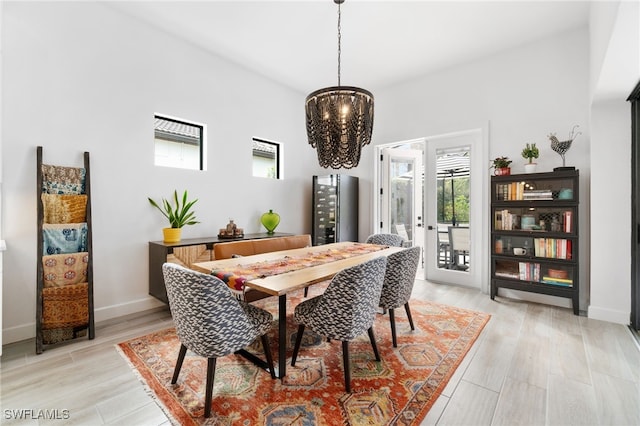 dining room featuring an inviting chandelier and light wood-type flooring