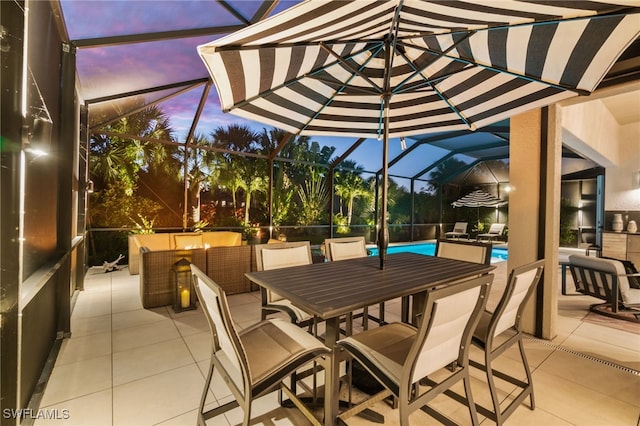 patio terrace at dusk featuring glass enclosure