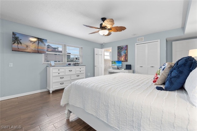 bedroom featuring ceiling fan, dark hardwood / wood-style floors, a closet, and a textured ceiling