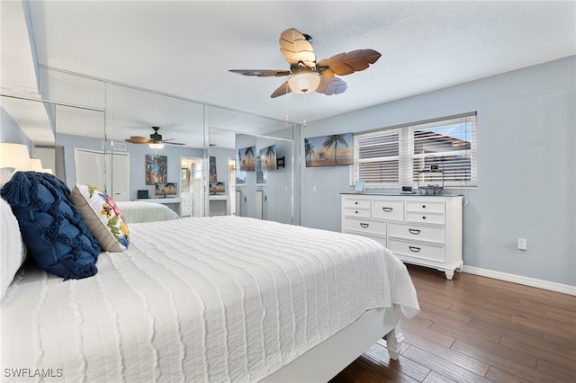 bedroom featuring ceiling fan, dark hardwood / wood-style flooring, and a textured ceiling