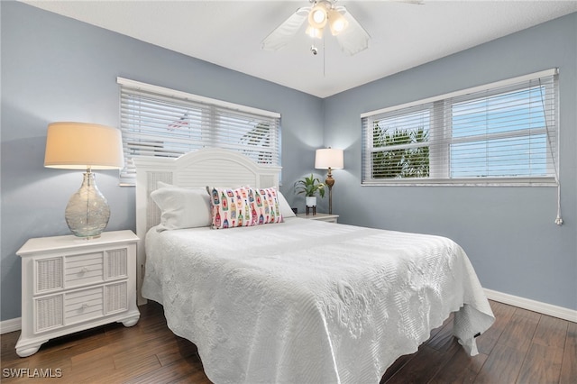 bedroom with ceiling fan and dark hardwood / wood-style floors