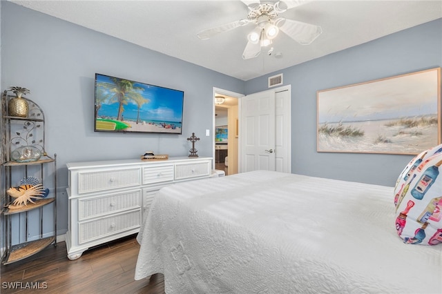 bedroom featuring dark wood-type flooring, ceiling fan, and a closet