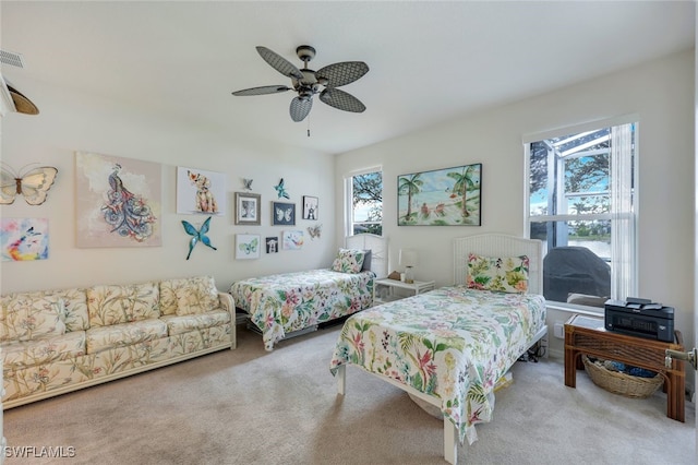 bedroom with ceiling fan and light carpet