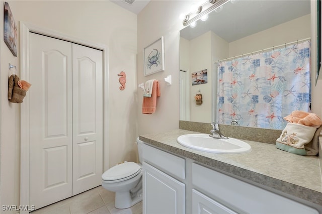 bathroom with toilet, tile patterned floors, and vanity