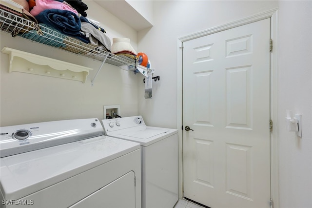 clothes washing area with washing machine and dryer