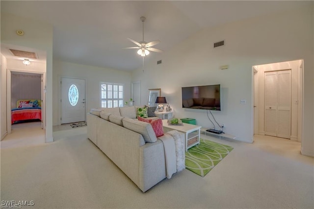 carpeted living room with high vaulted ceiling and ceiling fan