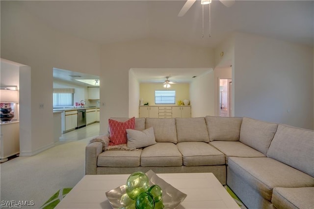 living room featuring ceiling fan, light colored carpet, and vaulted ceiling