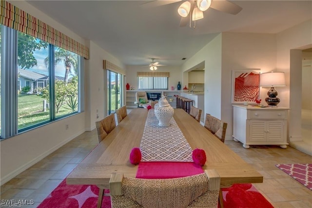 dining space with ceiling fan and sink