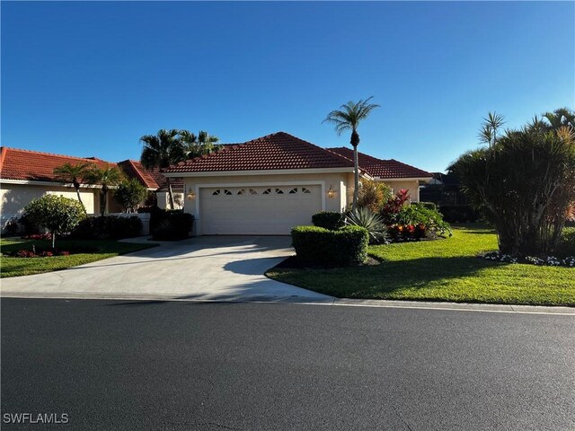 view of front of home featuring a garage and a front yard