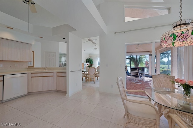 tiled dining room featuring ceiling fan and sink