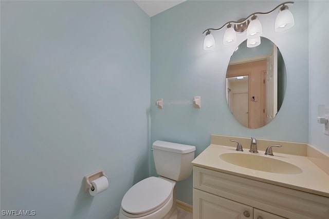 bathroom featuring toilet and vanity