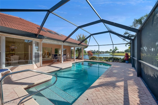 outdoor pool featuring a lanai, a water view, and a patio area