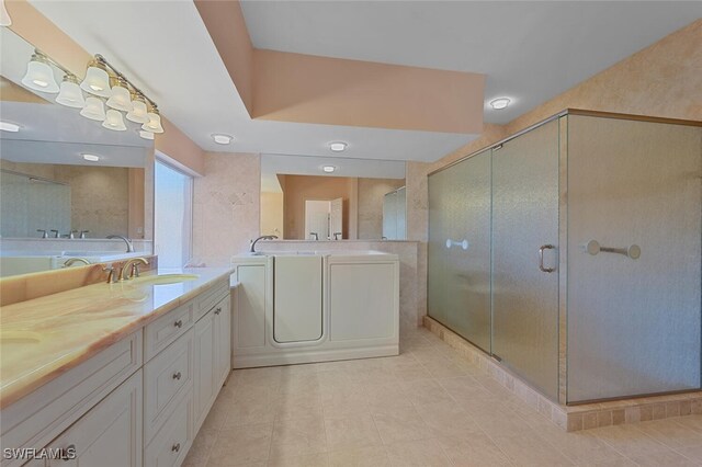 bathroom with vanity, an enclosed shower, and tile patterned flooring