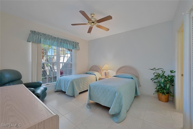 bedroom with a ceiling fan and light tile patterned floors