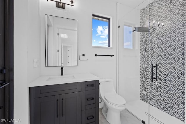 bathroom with vanity, toilet, and a shower