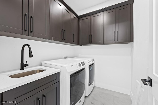 laundry area with cabinets, sink, and washing machine and clothes dryer