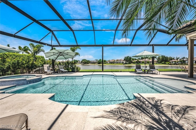 view of pool with an in ground hot tub, a water view, glass enclosure, and a patio area