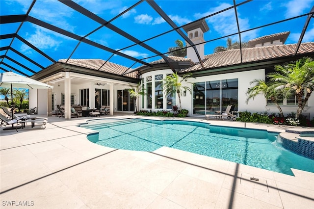 view of swimming pool with a lanai, a patio area, and ceiling fan