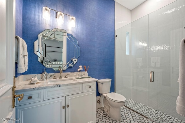 bathroom featuring walk in shower, vanity, and toilet