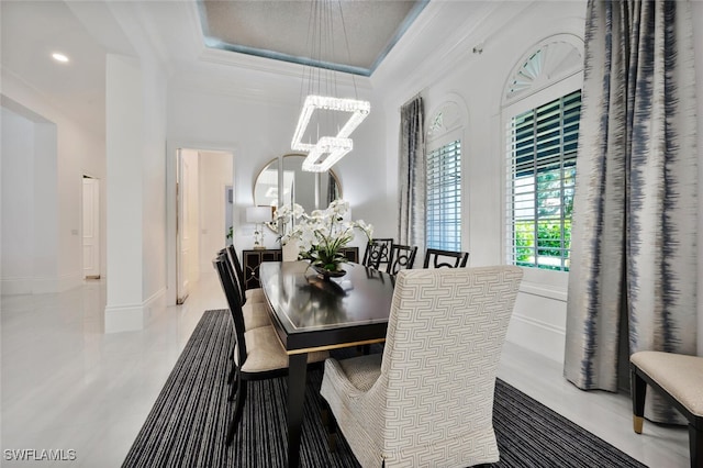 dining room featuring ornamental molding and a notable chandelier