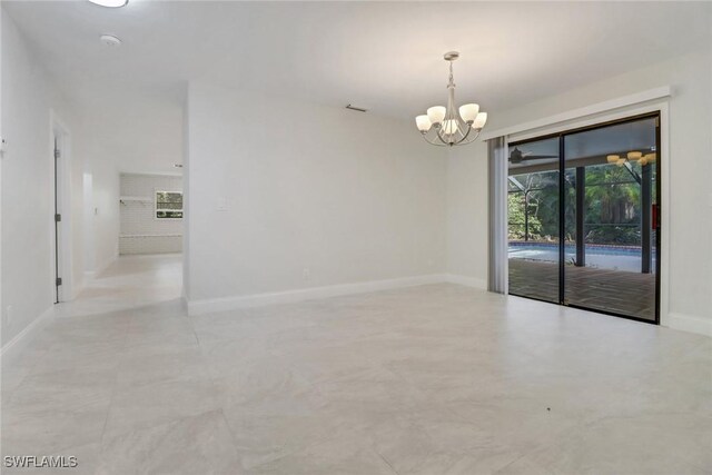 empty room featuring an inviting chandelier