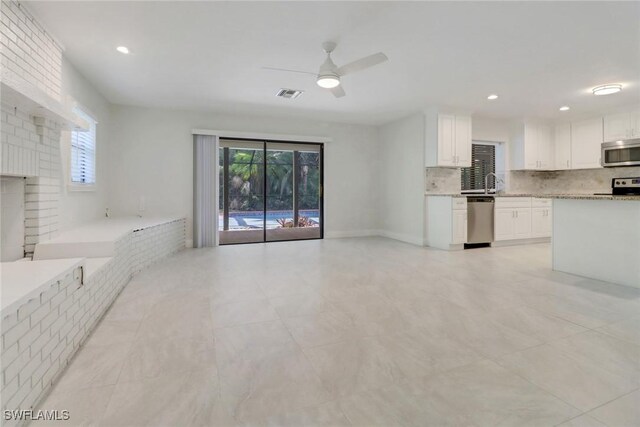 unfurnished living room featuring ceiling fan