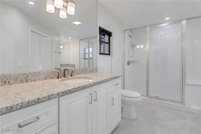 bathroom with vanity, toilet, and walk in shower