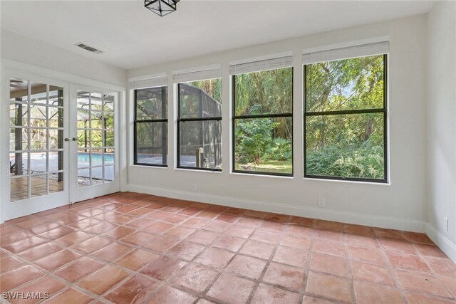 unfurnished sunroom featuring french doors