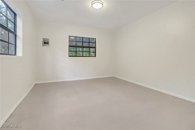 empty room with concrete flooring