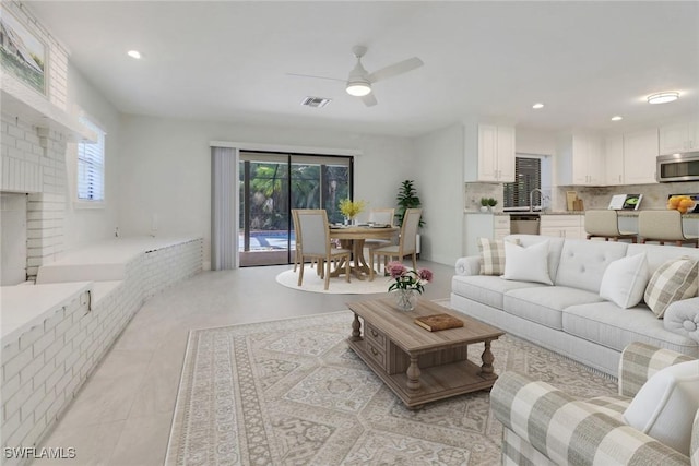 living room featuring ceiling fan and light tile patterned floors