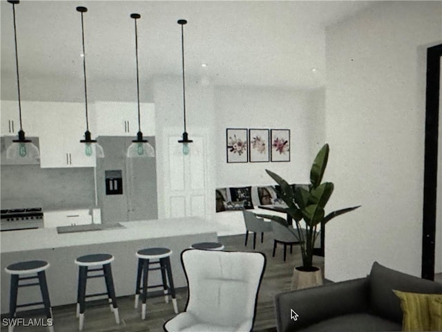 kitchen featuring white cabinetry, a kitchen breakfast bar, and hanging light fixtures