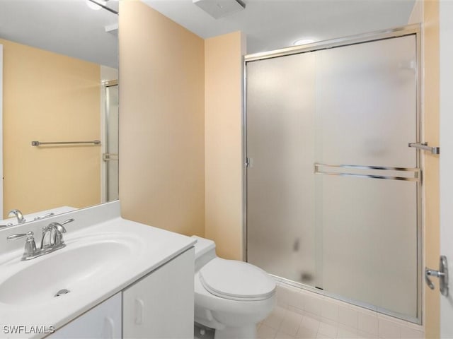 bathroom with vanity, toilet, and an enclosed shower