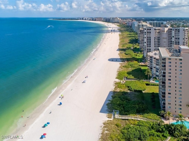 bird's eye view featuring a water view and a view of the beach