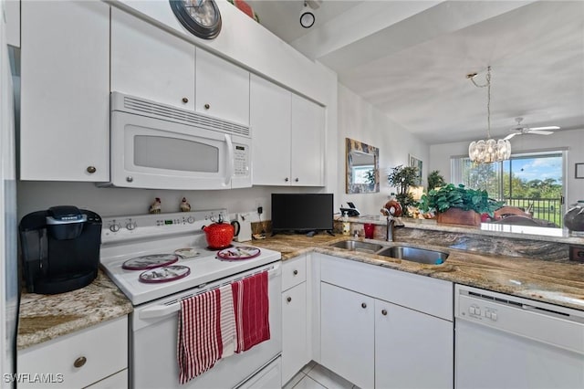 kitchen featuring sink, white appliances, an inviting chandelier, light stone counters, and white cabinets