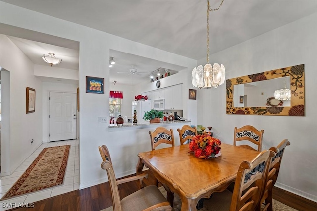 dining area featuring light wood-type flooring and ceiling fan