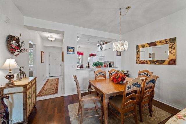 dining room with hardwood / wood-style flooring and ceiling fan