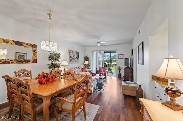 dining space featuring ceiling fan with notable chandelier and dark wood-type flooring