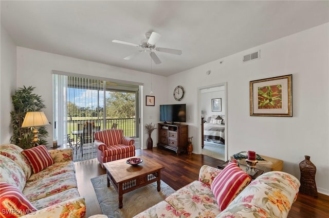 living room with dark hardwood / wood-style floors and ceiling fan