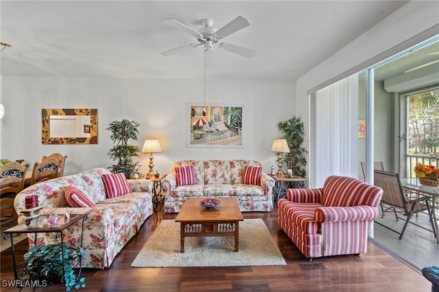 living room featuring ceiling fan and dark hardwood / wood-style flooring