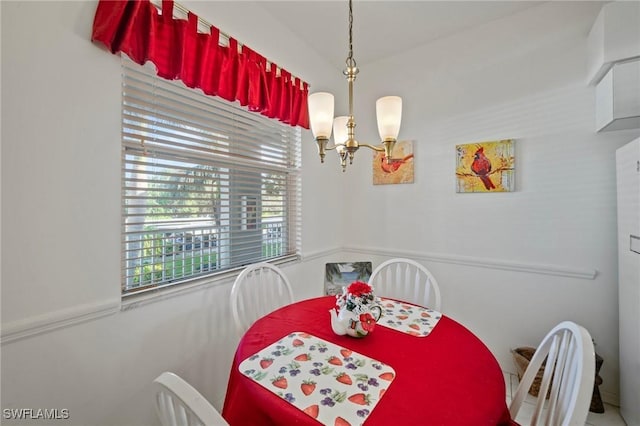 dining space with an inviting chandelier